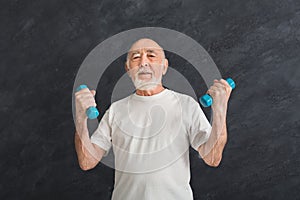 Senior man making exercise with dumbbells