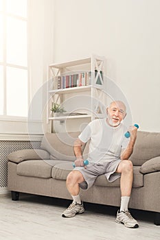 Senior man making exercise with dumbbells