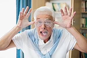 Senior man making faces