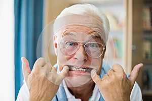Senior man making faces