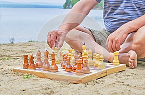A senior man making a move in a game of chess