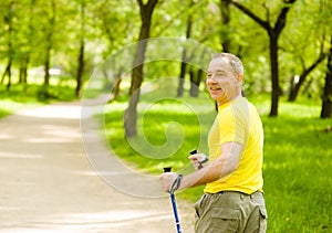 Senior man making nordic walking in the park