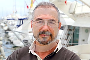 Senior man on marina sport boats portrait
