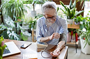 Senior man measuring blood pressure