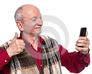 Senior man with mobile phone posing in studio