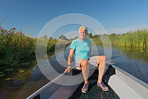 Senior man in motor boat