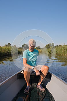 Senior man in motor boat