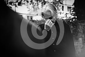 Senior Man Mourning By A Beloved`s Grave