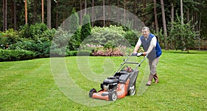 Senior man mowing the lawn. photo