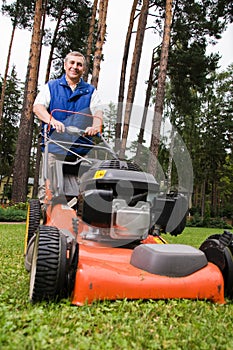 Senior man mowing the lawn.