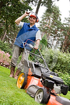 Senior man mowing the lawn.