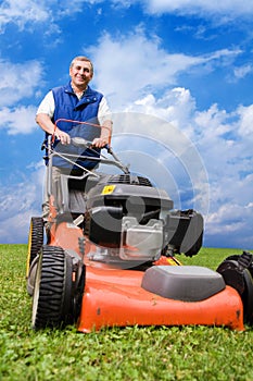 Senior man mowing the lawn.