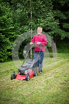 Senior man mowing the lawn