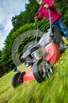 Senior man mowing the lawn