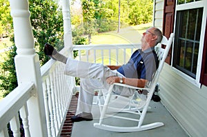 Senior man naps on front porch