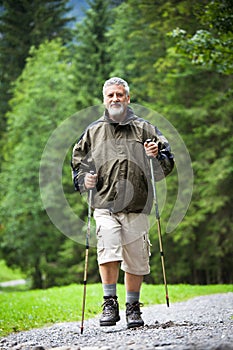 Senior man nordic walking outdoors
