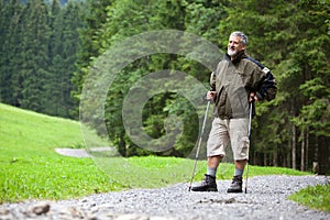 Senior man nordic walking outdoors