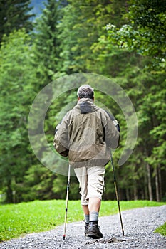 Senior man nordic walking outdoors
