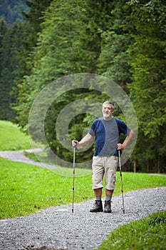 Senior man nordic walking outdoors