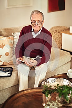 Senior man, notebook and sofa in portrait for budget, finance and retirement funds in living room. Elderly person