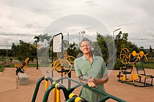 Senior Man outside at a Small Fitness Park
