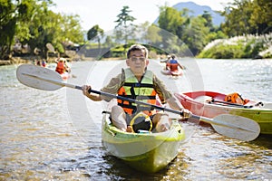 Senior man paddling kayak