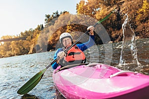 Senior man paddling kayak. Gray hair man enjoy river kayaking