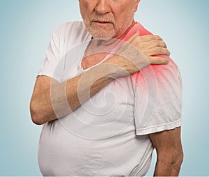 Senior man with pain in his shoulder isolated blue background