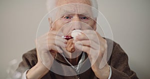 Senior man painting easter egg