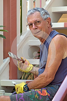 Senior man painting home