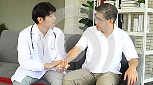 Senior man Patient Suffering From Depression shaking hands with doctor