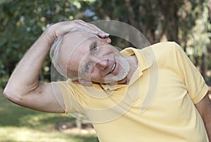 Senior man performing neck stretch