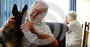 Senior man petting his dog at retirement home 4k