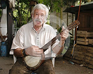 Senior man playing the banjo