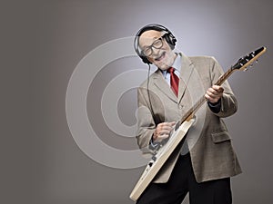 Senior man playing electric guitar