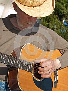 Senior man playing guitar