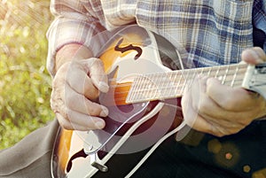 Senior man playing mandolin