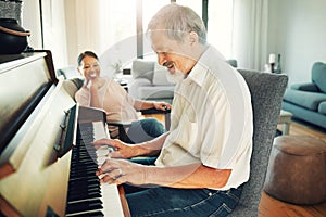Senior man playing piano for music in living room with wife for bonding, entertainment or having fun. Happy, smile and
