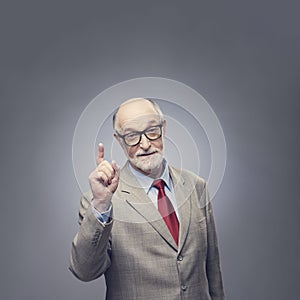 Senior man points finger up