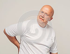 Senior man portrait back pain white background