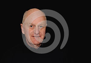 Senior man portrait on black
