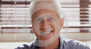 Senior man, portrait and closeup in house with smile for retirement, memories and happiness. Elderly person, face and