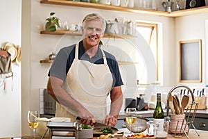 Senior man portrait, cooking in kitchen and prepare food, lunch meal and dinner in home. Happy mature house chef chop