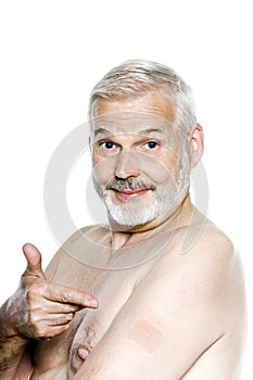 Senior man portrait showing nicotine patch photo