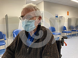 Senior man wearing a face mask in hospital photo