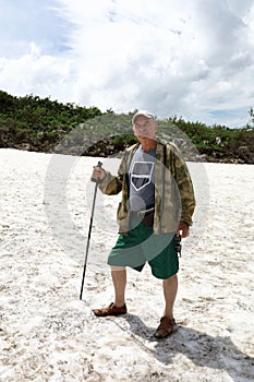 Senior man posing on glacier of Lago-Naki plateau