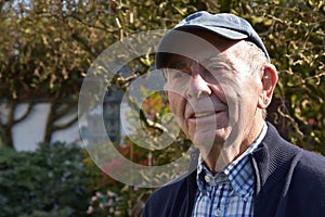 Senior man posing for a portrait in his garden