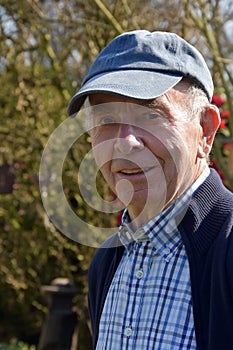 Senior man posing for a portrait in his garden