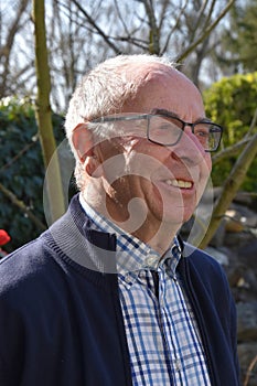 Senior man posing for a portrait in his garden