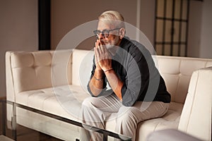 Senior man praying at home. Praise God, Godly Catholic photo